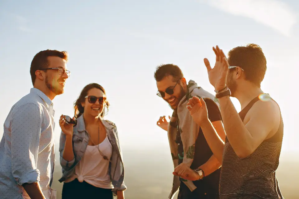 Friends laughing together at golden hour